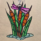 A 3d printed ornament depicting cattails, reeds, and a dragonfly, with a hanging loop at the top, shown against a neutral beige background.