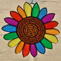 A 3D printed sunflower ornament with a brown textured center and rainbow-colored petals, hanging against a neutral beige background.