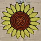 A 3D printed sunflower ornament with a textured brown center and bright yellow-green petals outlined in black, suspended by a clear hook at the top against a neutral background.